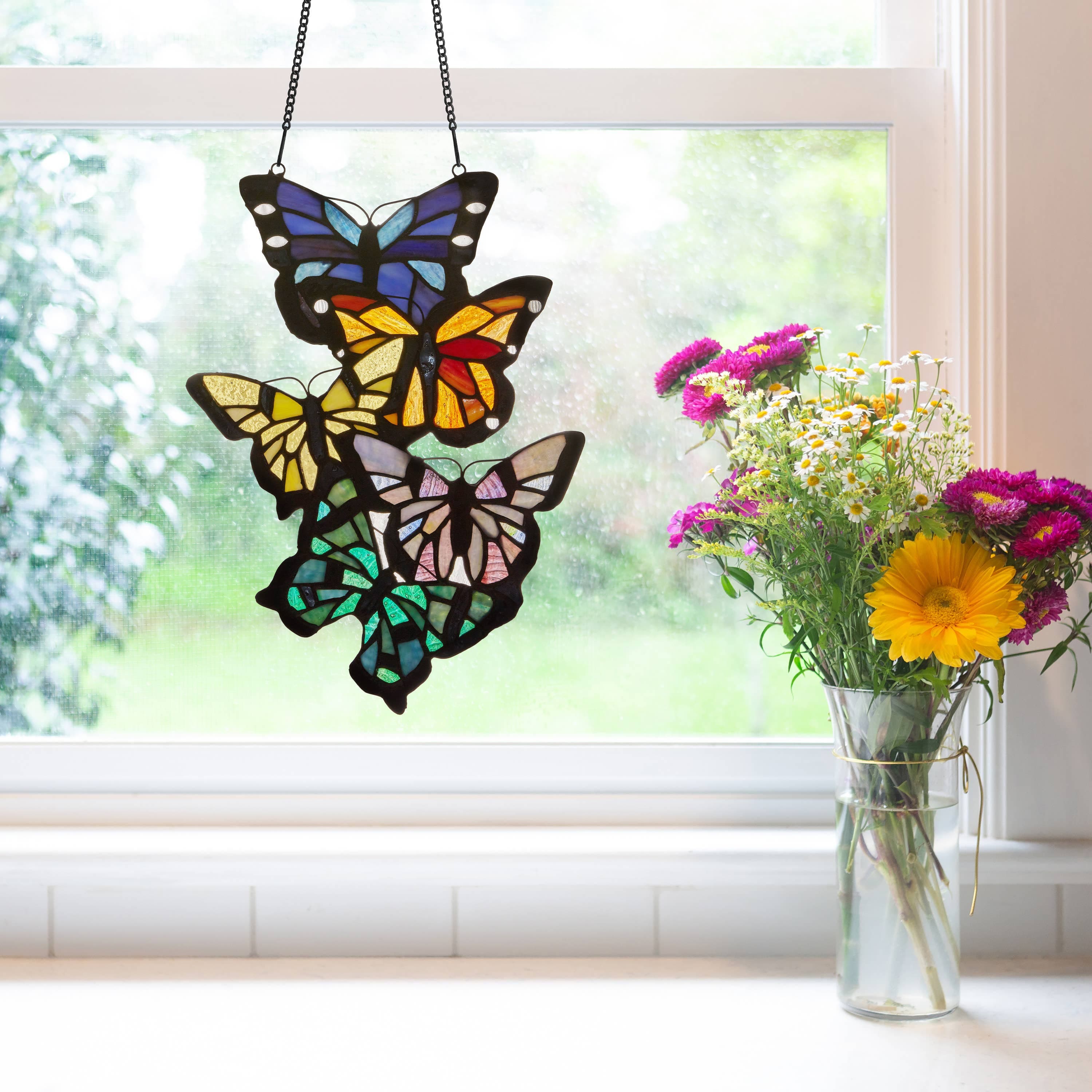 https://cdn.shopify.com/s/files/1/0016/1300/4872/files/river-of-goods-river-of-goods-13-25-h-butterfly-cluster-stained-glass-window-panel-1129246587.jpg?v=1739235922
