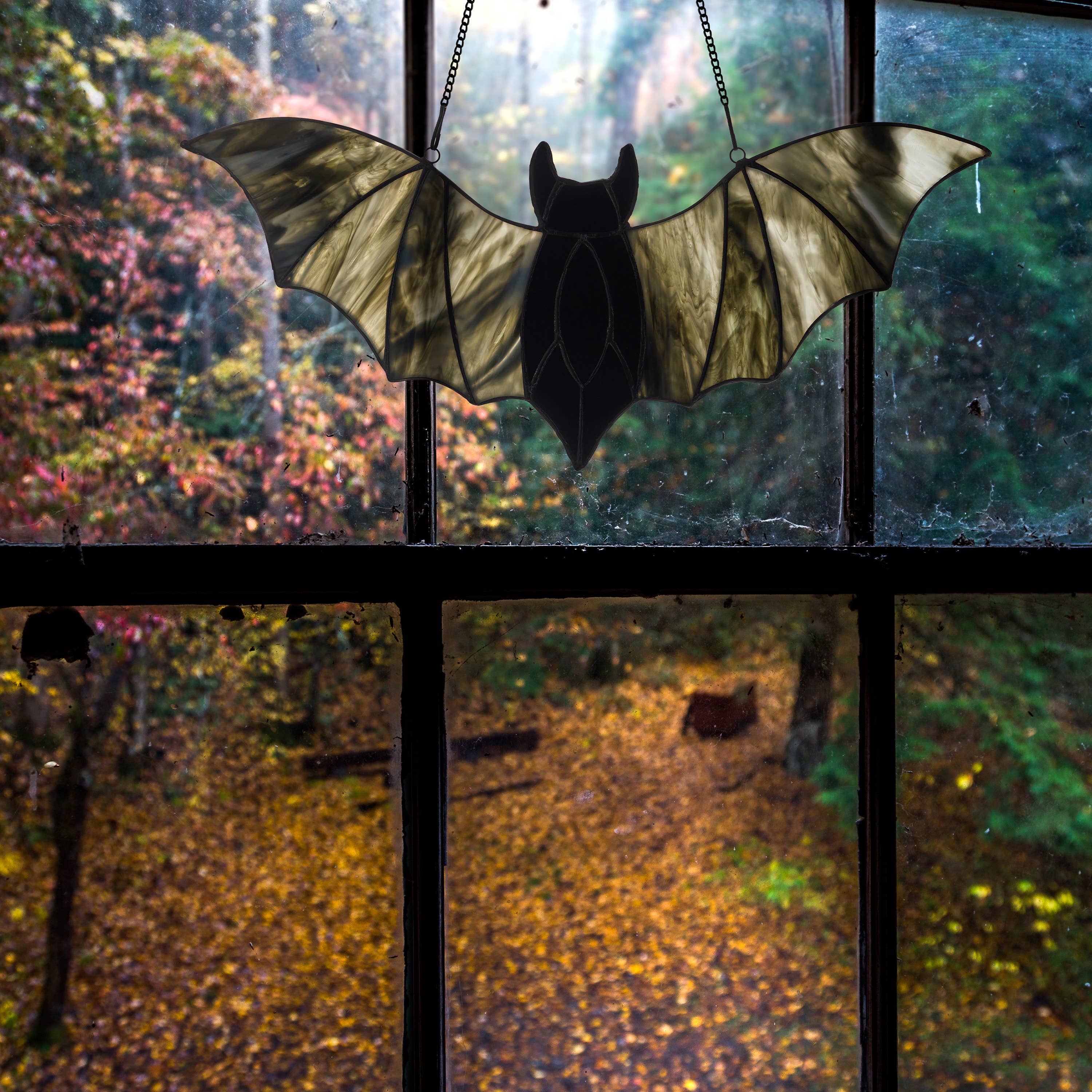 https://cdn.shopify.com/s/files/1/0016/1300/4872/files/river-of-goods-river-of-goods-16-w-halloween-black-bat-stained-glass-window-panel-1192404966.jpg?v=1757625464