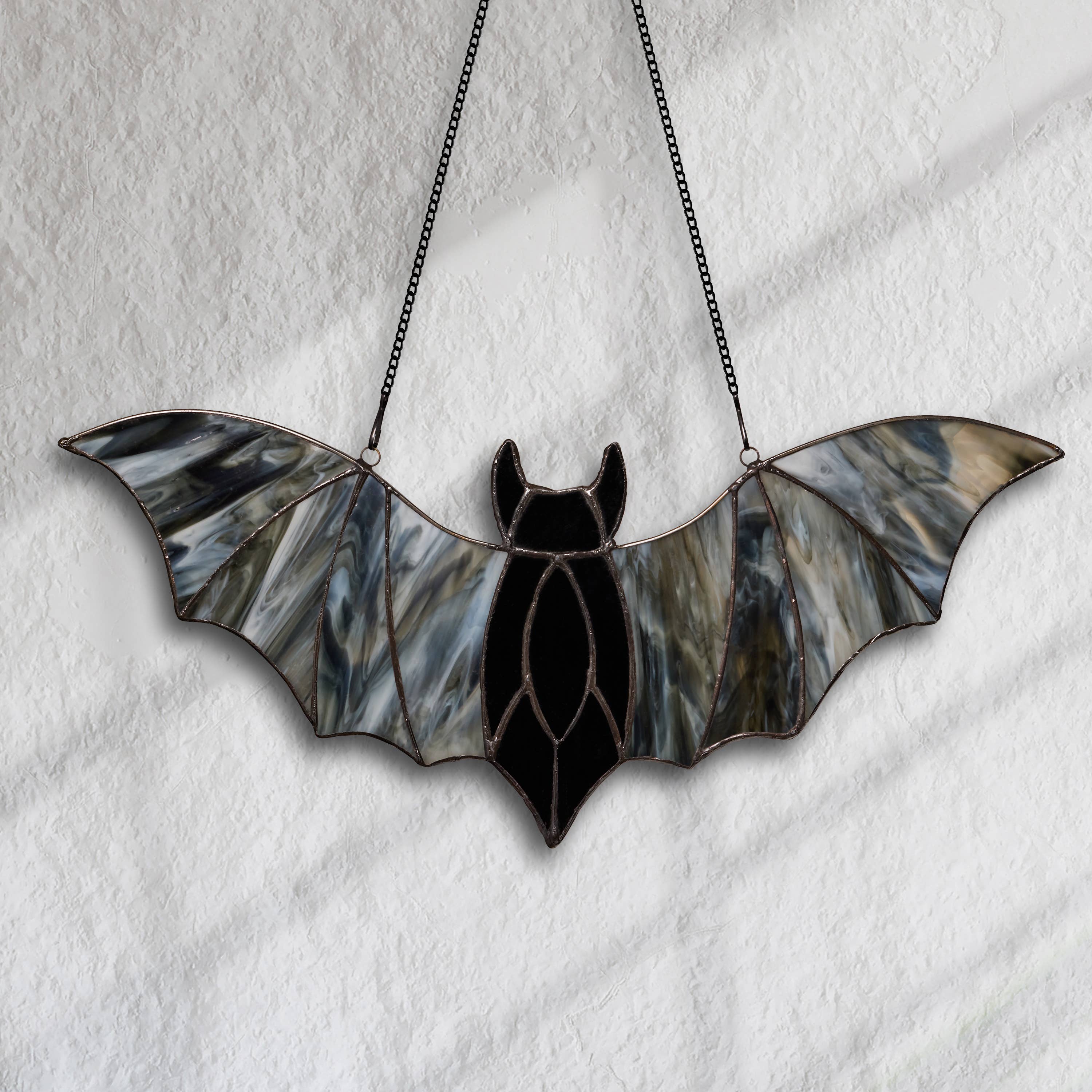 https://cdn.shopify.com/s/files/1/0016/1300/4872/files/river-of-goods-river-of-goods-16-w-halloween-black-bat-stained-glass-window-panel-1192404975.jpg?v=1757625689