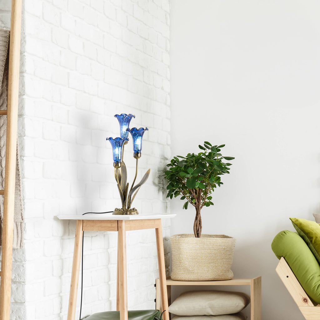 https://cdn.shopify.com/s/files/1/0016/1300/4872/files/river-of-goods-river-of-goods-21-h-blue-mercury-glass-3-lily-uplight-table-lamp-1212805660.jpg?v=1766441487