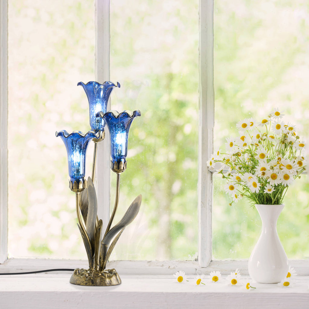https://cdn.shopify.com/s/files/1/0016/1300/4872/files/river-of-goods-river-of-goods-21-h-blue-mercury-glass-3-lily-uplight-table-lamp-1212805662.jpg?v=1766441129