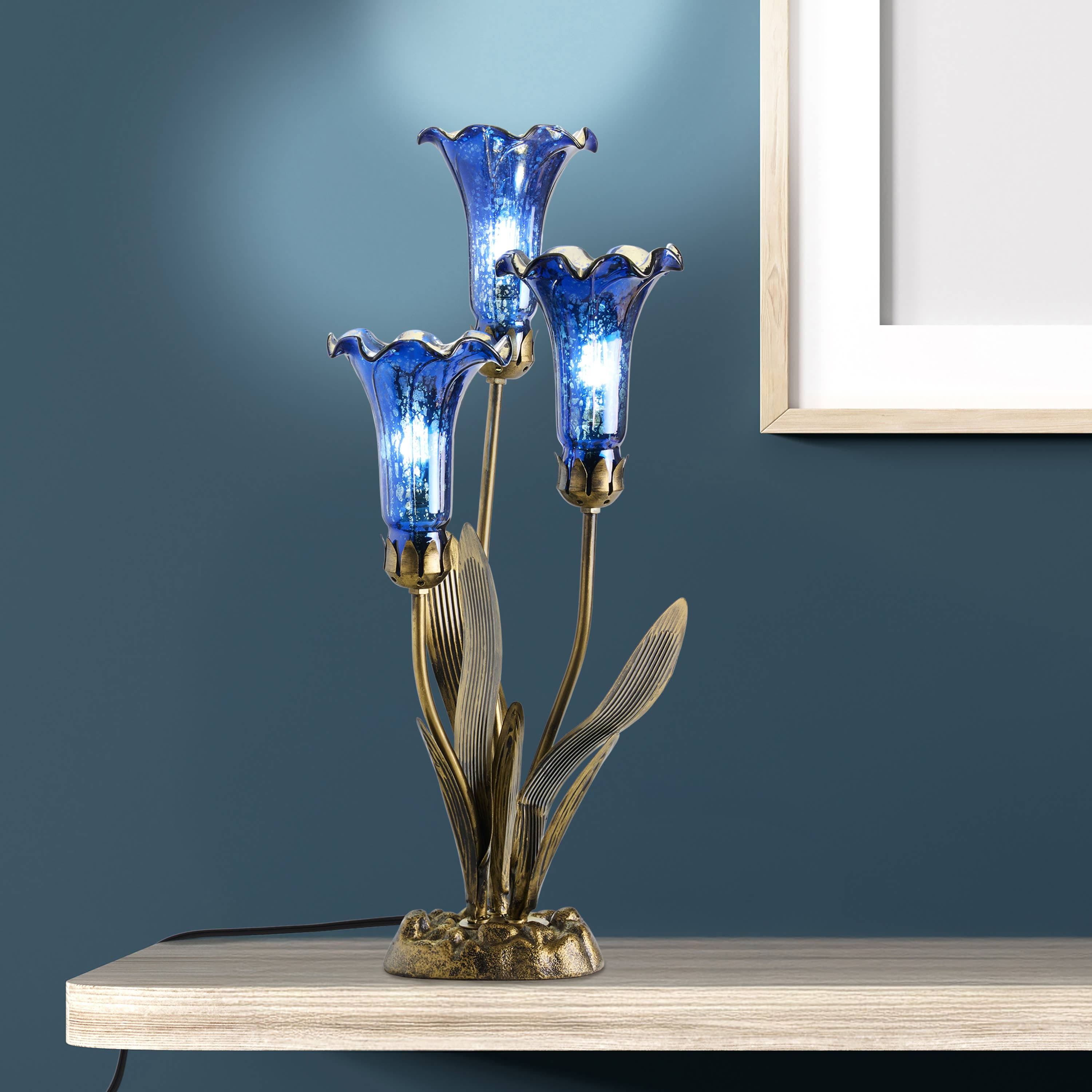 https://cdn.shopify.com/s/files/1/0016/1300/4872/files/river-of-goods-river-of-goods-21-h-blue-mercury-glass-3-lily-uplight-table-lamp-1212805664.jpg?v=1766441244